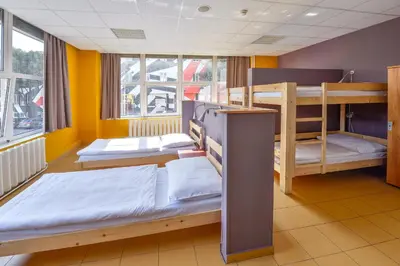 two bunk beds in a room with yellow walls at Plus Prague in Prague