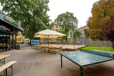 a group of tables and umbrellas on a street at Plus Prague in Prague