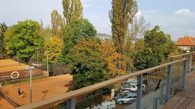 a view of a parking lot with cars parked at Sport Pension Cibulka in Prague