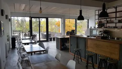 a restaurant with tables and chairs in a room at Sport Pension Cibulka in Prague