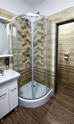a bathroom with a shower and a sink at Hotel Sýkora in Křivoklát