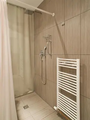 a bathroom with a shower with a shower curtain at Hotel PurPur in Prague