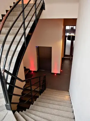 a spiral staircase in a building with a hallway at Hotel PurPur in Prague