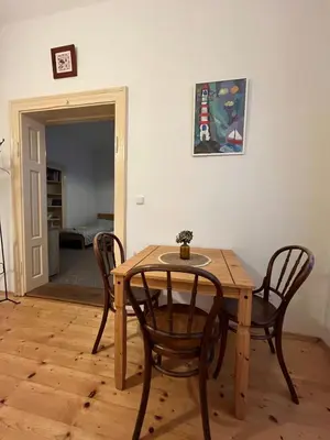a wooden table and chairs in a room at Apartment Žižkova 159, Terezín in Terezín