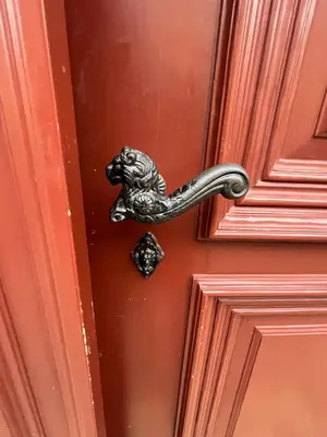 a doorhandle to a red door with a dog handle at Apartment Žižkova 159, Terezín in Terezín