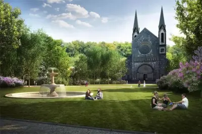 a group of people sitting on the grass in front of a church at LOVELY Prague Apartment in Prague