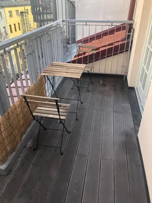a balcony with two benches and a table on a balcony at Old Strand Spirit in Prague