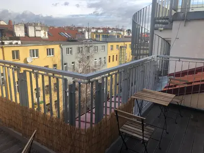 a balcony with a bench and a view of a city at Old Strand Spirit in Prague