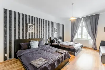 a bedroom with two beds and a striped wall at Old Strand Spirit in Prague