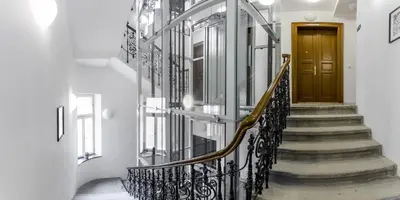 a hallway with stairs and a wooden door at Old Strand Spirit in Prague