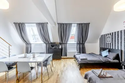 a living room with a bed and a table at Riverside SPIRIT in Prague