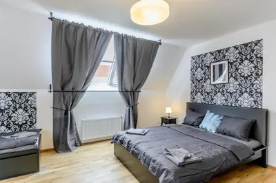 a bedroom with a large bed and a window at Riverside SPIRIT in Prague