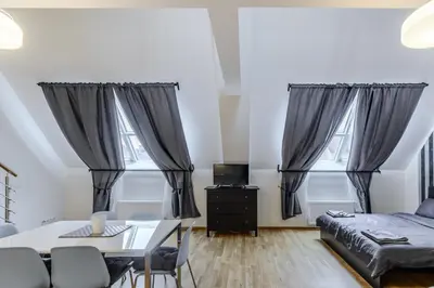 a living room with a bed and a table at Riverside SPIRIT in Prague