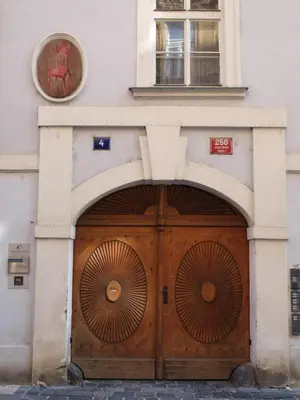 a building with a large wooden door with a window at U Cervene zidle - Red Chair Hotel in Prague