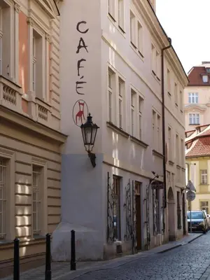 a building with a sign on the side of a street at U Cervene zidle - Red Chair Hotel in Prague