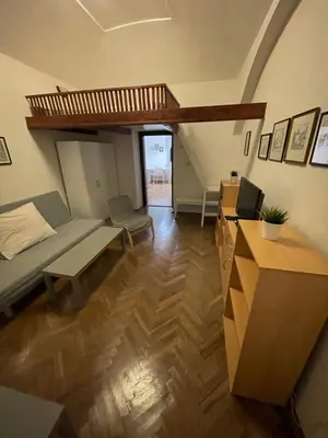 a room with a bed and a couch and a desk at Apartment Jackie in Prague