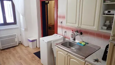 a small kitchen with a sink and a washing machine at Apartment Jackie in Prague