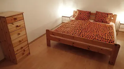 a bedroom with a bed with a dresser and a drawer at Apartment Jackie in Prague