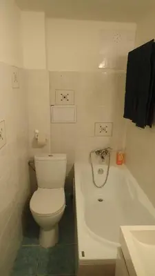 a bathroom with a toilet and a bath tub at Apartment Jackie in Prague