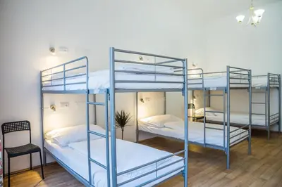 three blue bunk beds in a room with a chair at Hostel Little Quarter in Prague