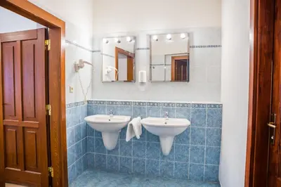 a bathroom with two sinks and a mirror at Hostel Little Quarter in Prague