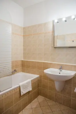 a bathroom with a sink and a bath tub at Hostel Little Quarter in Prague