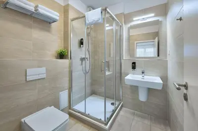 a bathroom with a shower and a toilet and a sink at CityWest Apartments in Prague