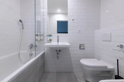 a bathroom with a toilet and a sink and a shower at Numa Prague Root in Prague