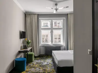 a hotel room with a bed and a window at Numa Prague Root in Prague