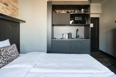 a person holding a sign on a shelf with towels at Numa Prague Root in Prague
