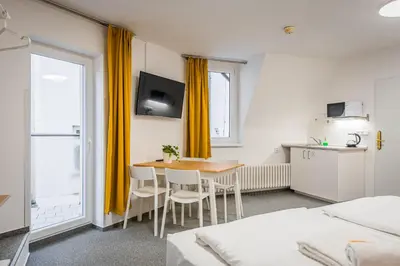a gold door handle on a white door at Self-service Hotel Ostaš Praha in Prague