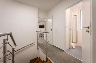 a staircase in a white room with a stair case at Self-service Hotel Ostaš Praha in Prague