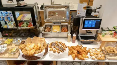 a counter with various types of bread and pastries at Self-service Hotel Ostaš Praha in Prague