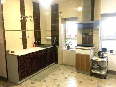 a large kitchen with a sink and a stove at Rezidence Jiskra in Brandýs nad Labem-Stará Boleslav