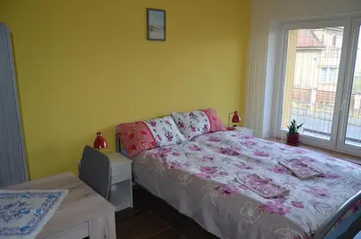 a bedroom with a bed and a table and a window at Rezidence Jiskra in Brandýs nad Labem-Stará Boleslav