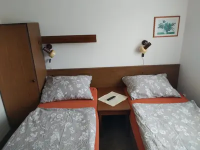a small room with two beds and a table at Pension Sparta in Prague