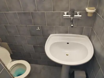 a bathroom with a white sink and a toilet at Pension Sparta in Prague