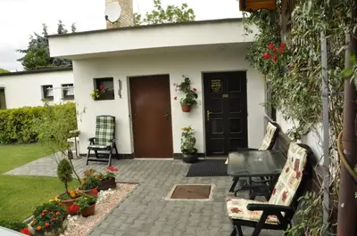 a patio with chairs and flowers in front of a house at Pension Sparta in Prague