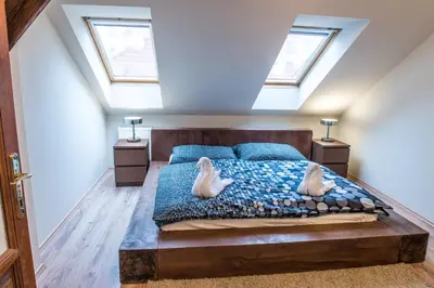 a bedroom with a bed with two swans on it at Spacious and Quiet Attic Flat in Centre in Prague