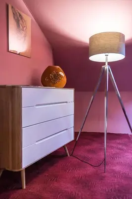 a bedroom with a dresser and a lamp at Spacious and Quiet Attic Flat in Centre in Prague