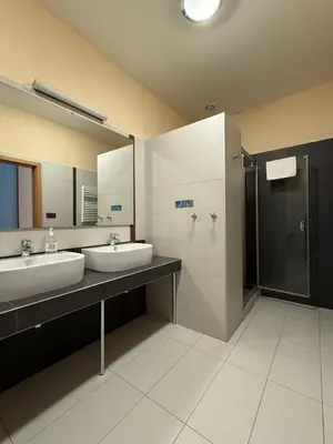 a bathroom with two sinks and a shower at Pension Milk Inn in Prague