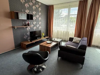 a living room with a couch and a chair at Pension Milk Inn in Prague