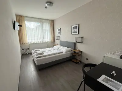 a bedroom with a bed and a window at Pension Milk Inn in Prague