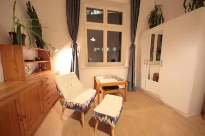 a room with two chairs and a table and a window at Gallery Apartment in Prague