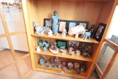a shelf with a bunch of figurines on it at Gallery Apartment in Prague