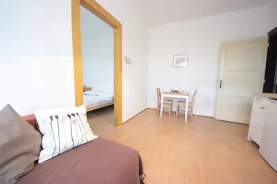 a room with a bed and a table with a kitchen at Gallery Apartment in Prague