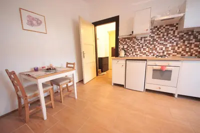 a kitchen and dining room with a table and chairs at Gallery Apartment in Prague