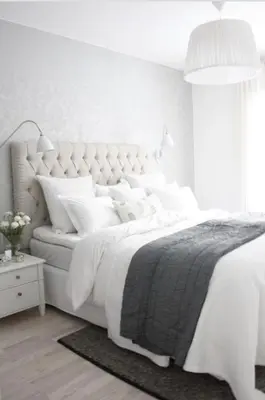 a white bedroom with a large white bed with white pillows at Romantic Apartment Petra - free parking Friday-Sunday in Prague