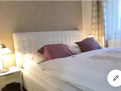 a bedroom with a large white bed with purple pillows at Romantic Apartment Petra - free parking Friday-Sunday in Prague