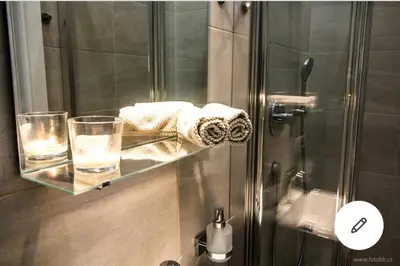 a glass shelf in a shower with two glasses of water at Romantic Apartment Petra - free parking Friday-Sunday in Prague